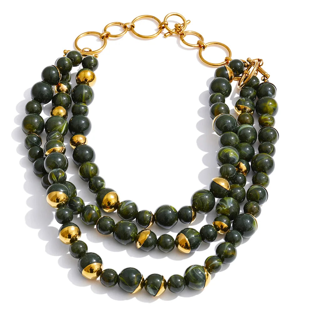 Three-strand layered necklace in forest green marbled beads with gold accents