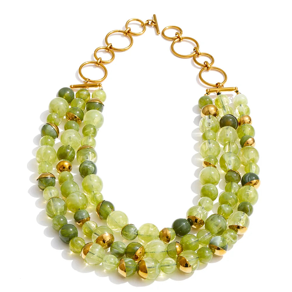 Three-strand layered necklace in spring green beads with gold accents