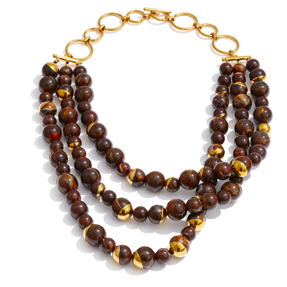 Three-strand layered necklace in tortoise marbled beads with gold accents