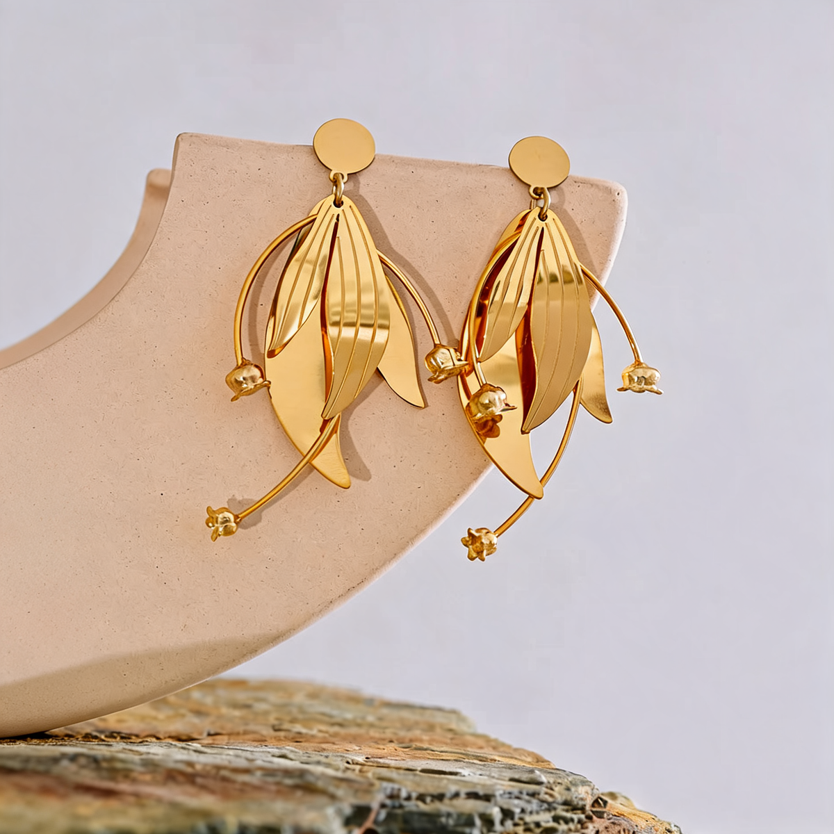 Annie Petal Drop Earrings styled on a ceramic form