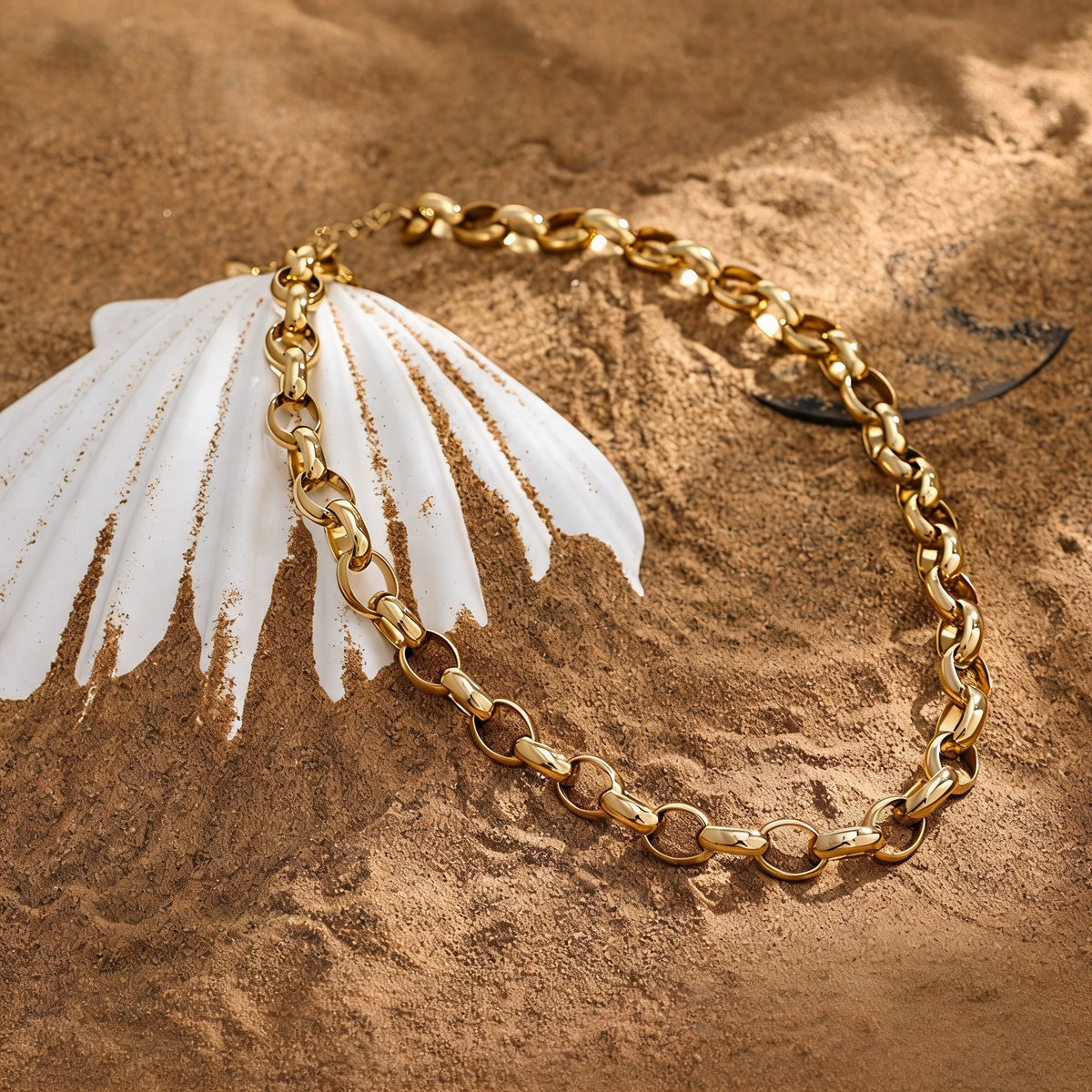 Canyon Textured Collar Necklace in warm gold-plated stainless steel styled on sand