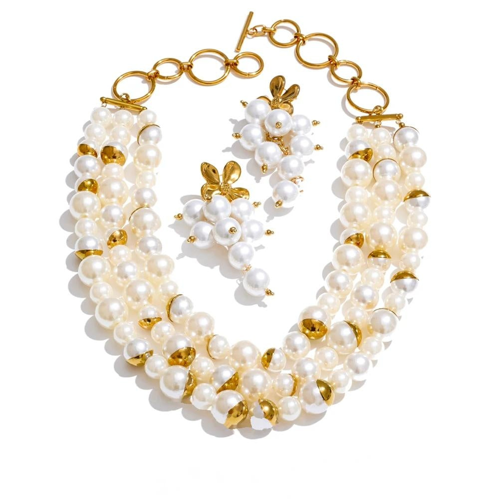Layered simulated pearl necklace with matching flower drop earrings