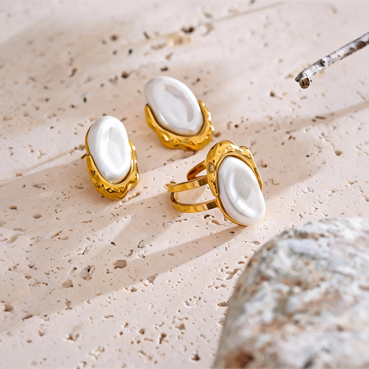 Maren pearl earrings and ring styled on travertine with a dried branch