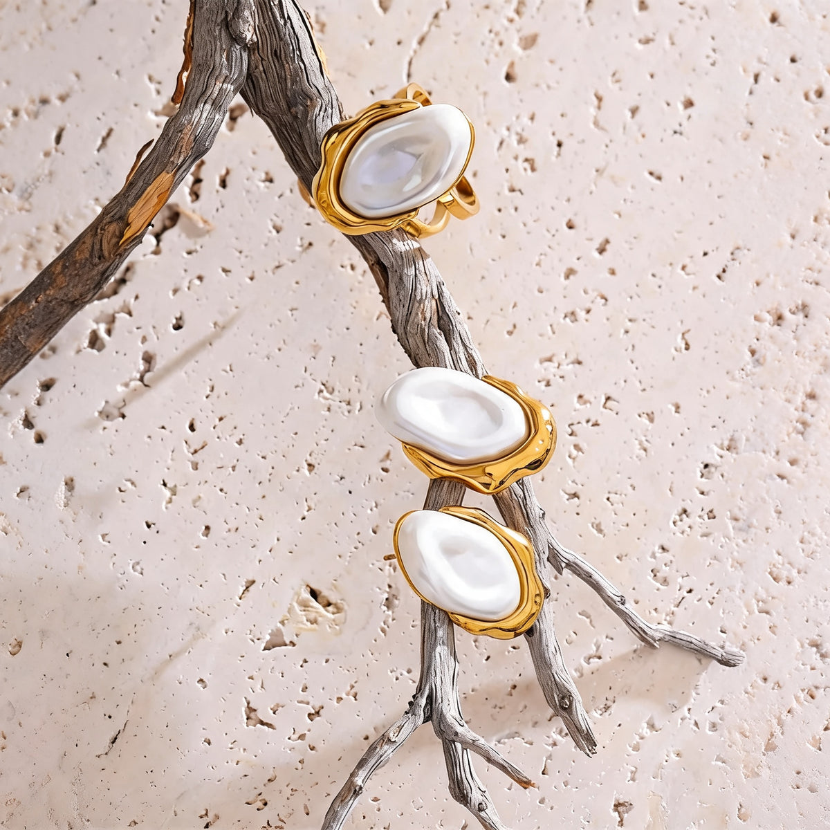 Maren pearl earrings and open ring arranged along a driftwood branch