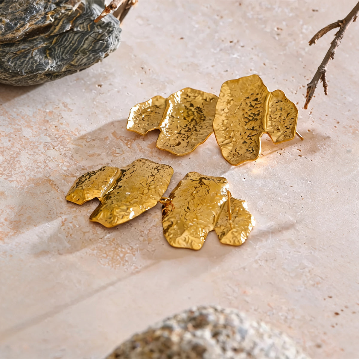 Faye hammered gold-tone drop earrings on travertine, alternate angle