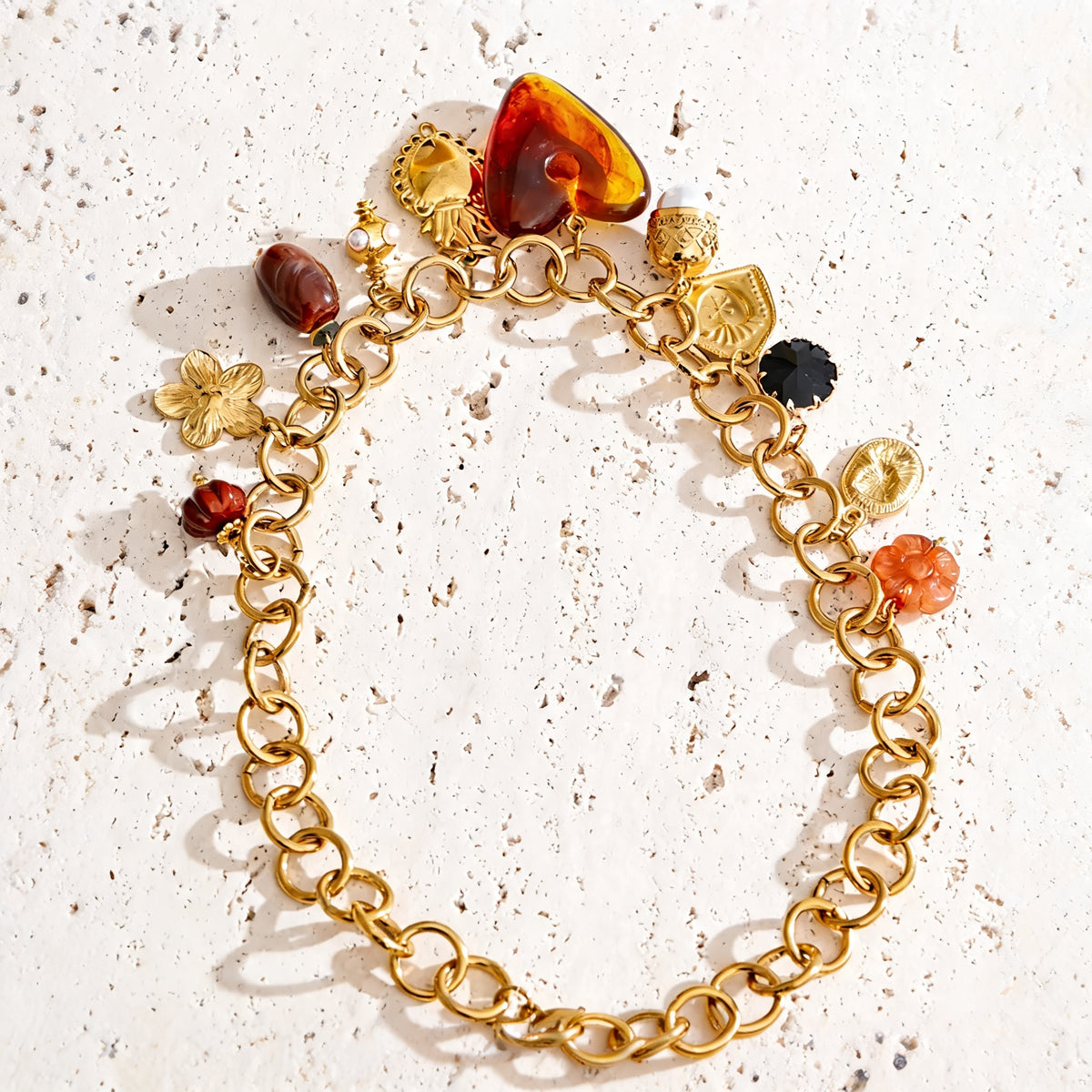Ramona Long Drop Necklace laid open on a travertine surface