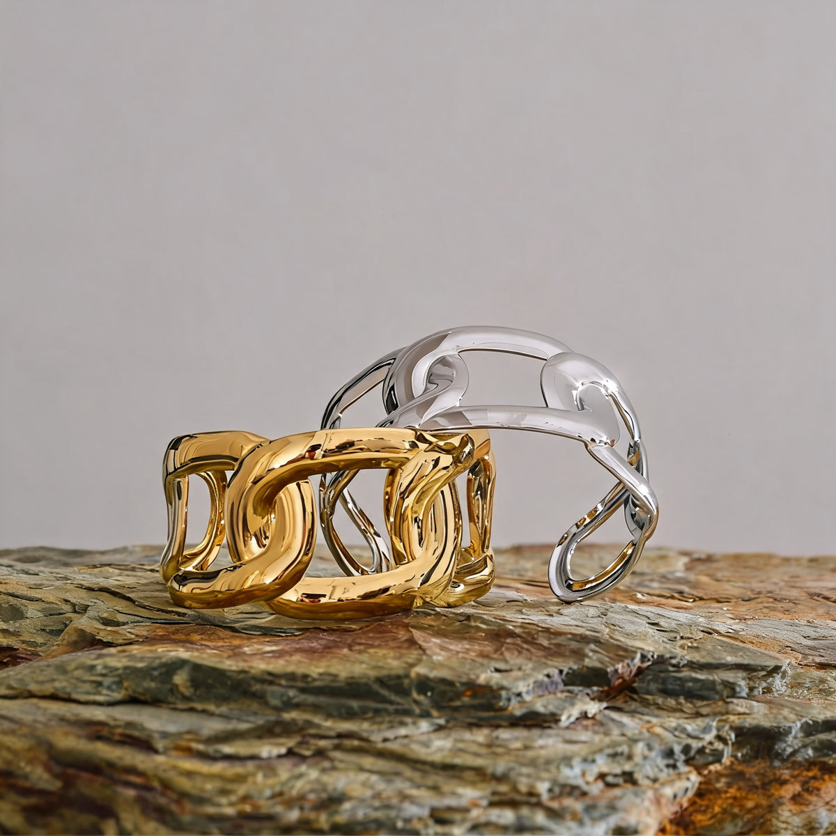 Hazel Chain Bangle pair on a stone ledge