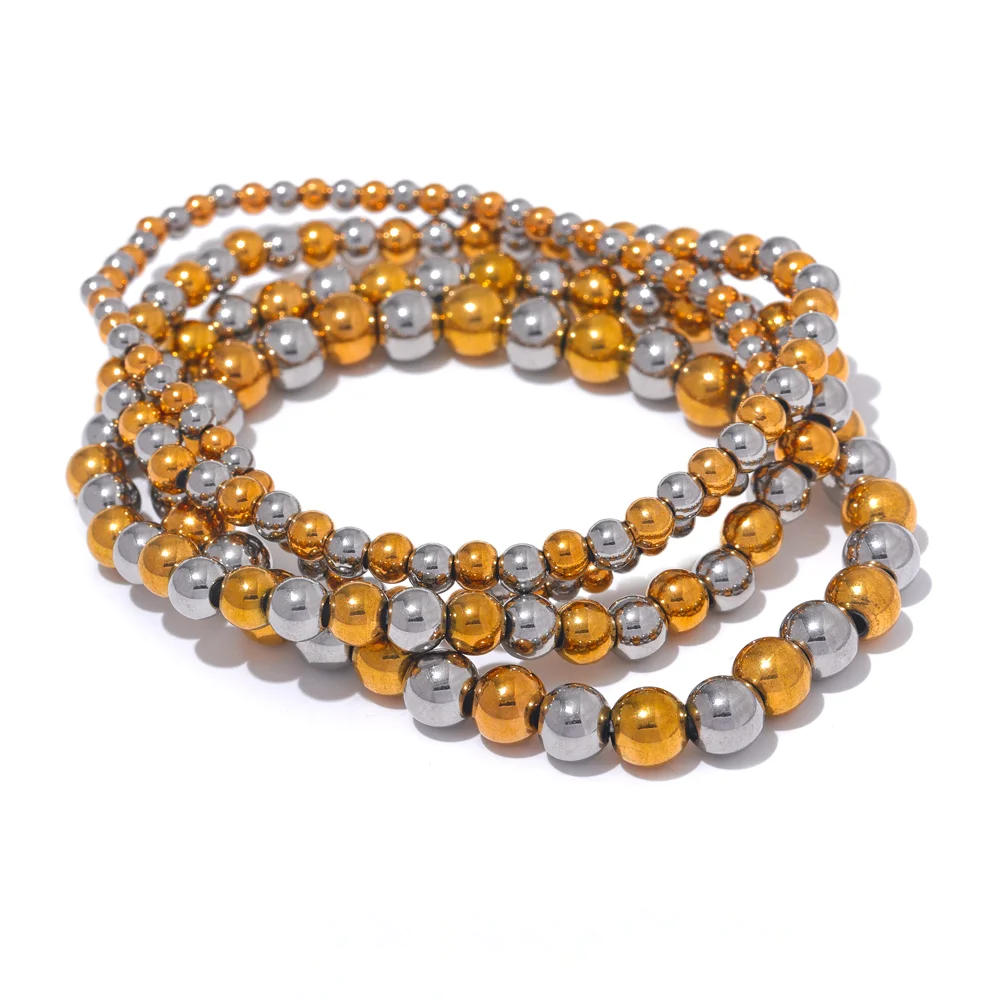 Two-tone beaded stretch bracelets stacked on a white background