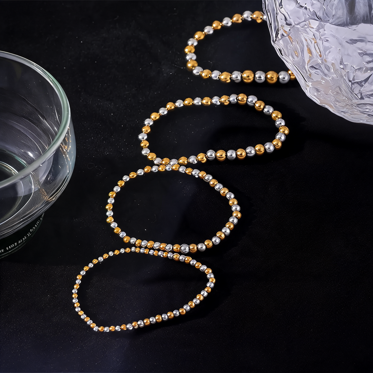 Four bead sizes of the stretch bracelet laid in a row