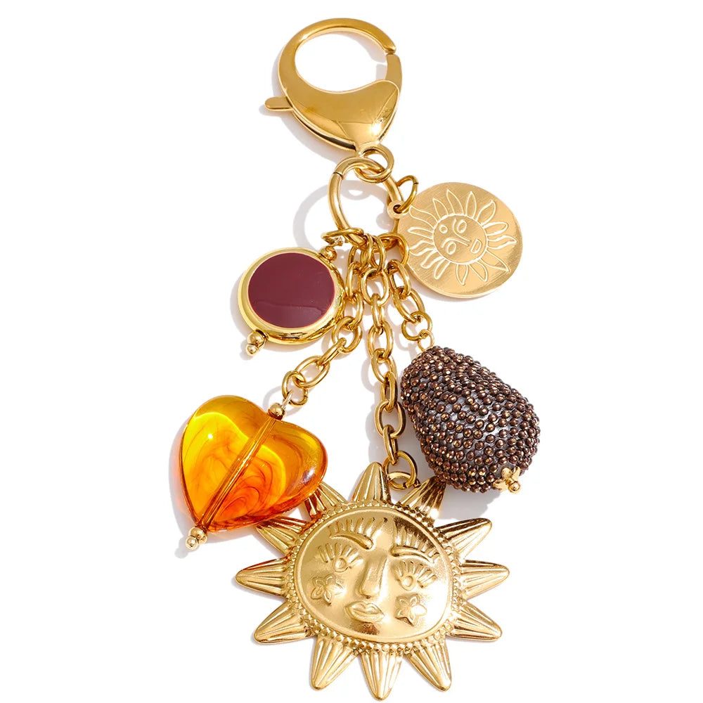 Marigold sun charm keychain in gold on a white background
