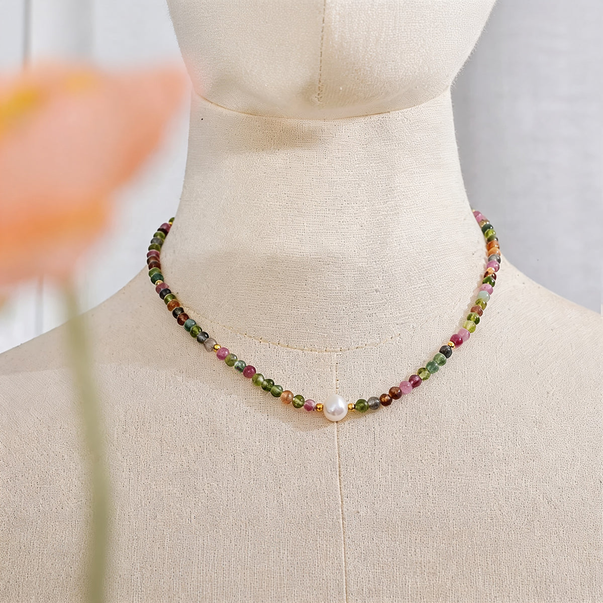Tourmaline bead necklace shown at neck height on a linen dress form