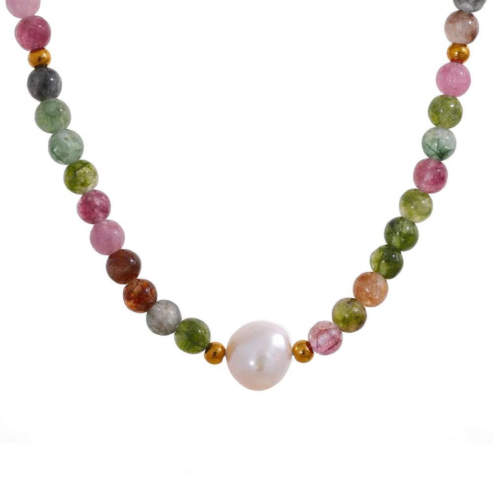 Macro detail of pink, green and amber tourmaline beads with gold-tone spacers