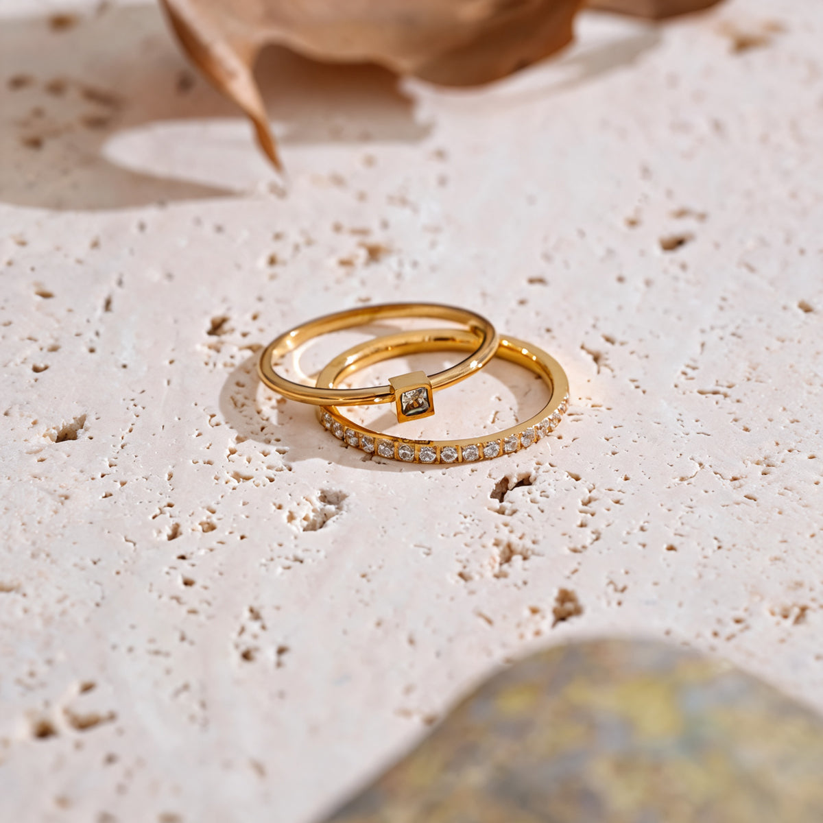 Rosie zirconia ring set on travertine with a dried petal