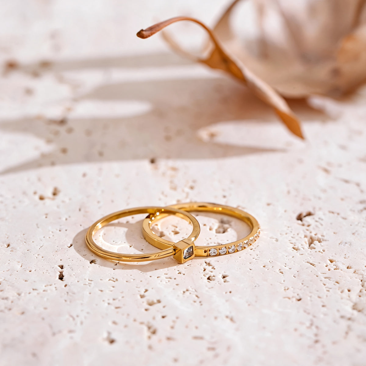 Rosie zirconia ring set laid flat on travertine