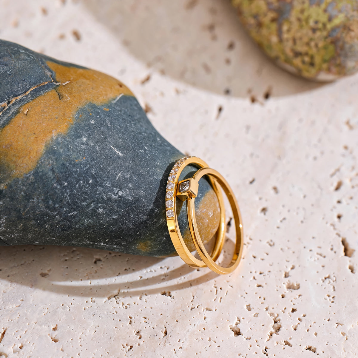 Rosie zirconia ring set against a blue-green stone